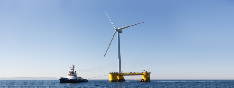 A tug boat with a wind turbine, at Celtic Freeport, one of the UK Freeports.